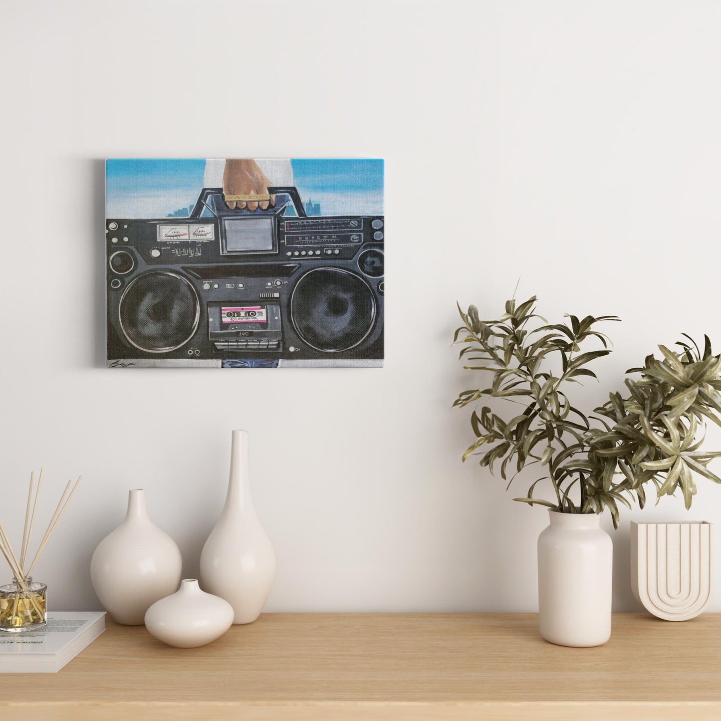 Painting titled “My Boom Box” showing a man in a white T-shirt holding a boombox with a BAIZE ring on his fingers and a faint city skyline in the background.