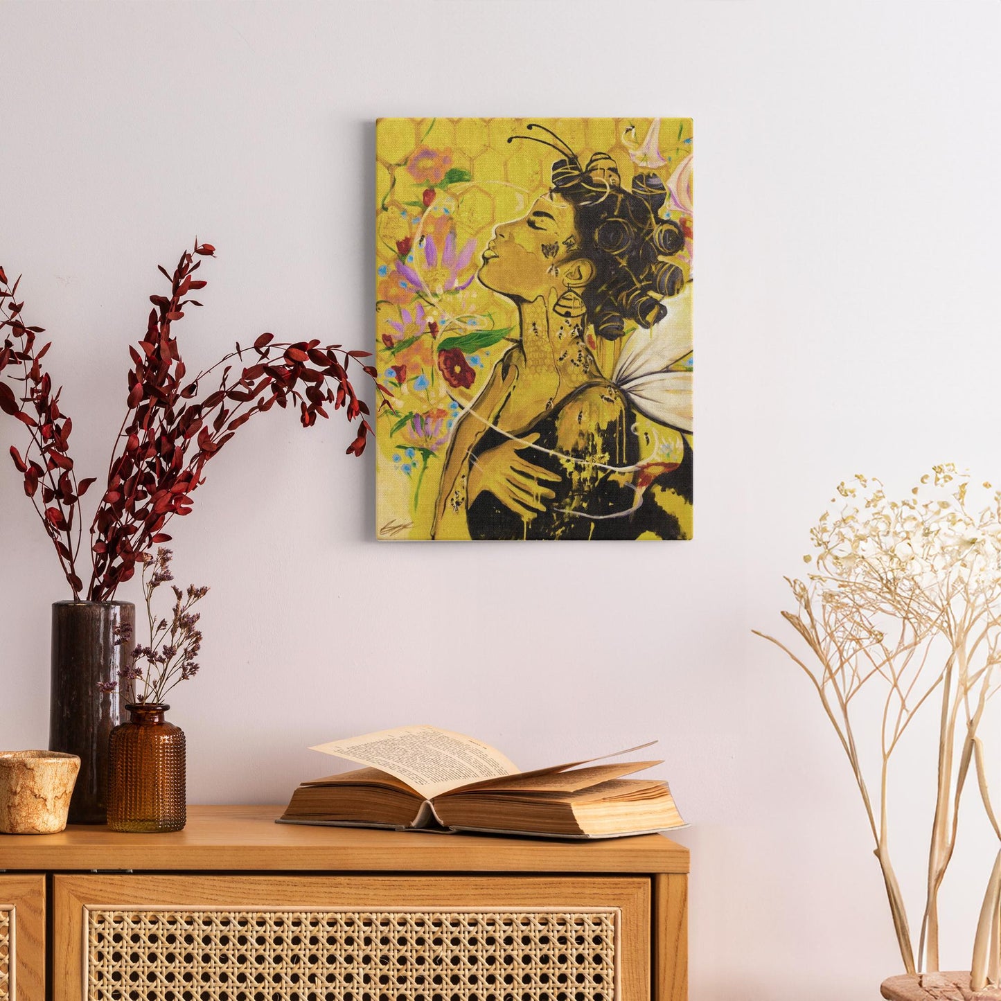 Painting titled “Angelic Butterfly” showing a Black woman with bantu knots, honey-dipped skin, butterfly wings, gold flakes, and bees in a bright yellow setting.