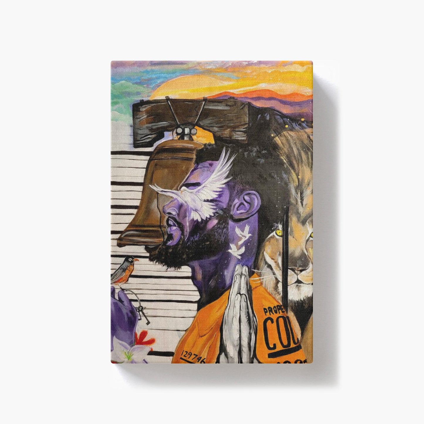 Painting titled “Give Me Liberty” showing a male in a prison jumpsuit kneeling in prayer with a symbolic lion behind bars, liberty bell, and doves representing freedom.