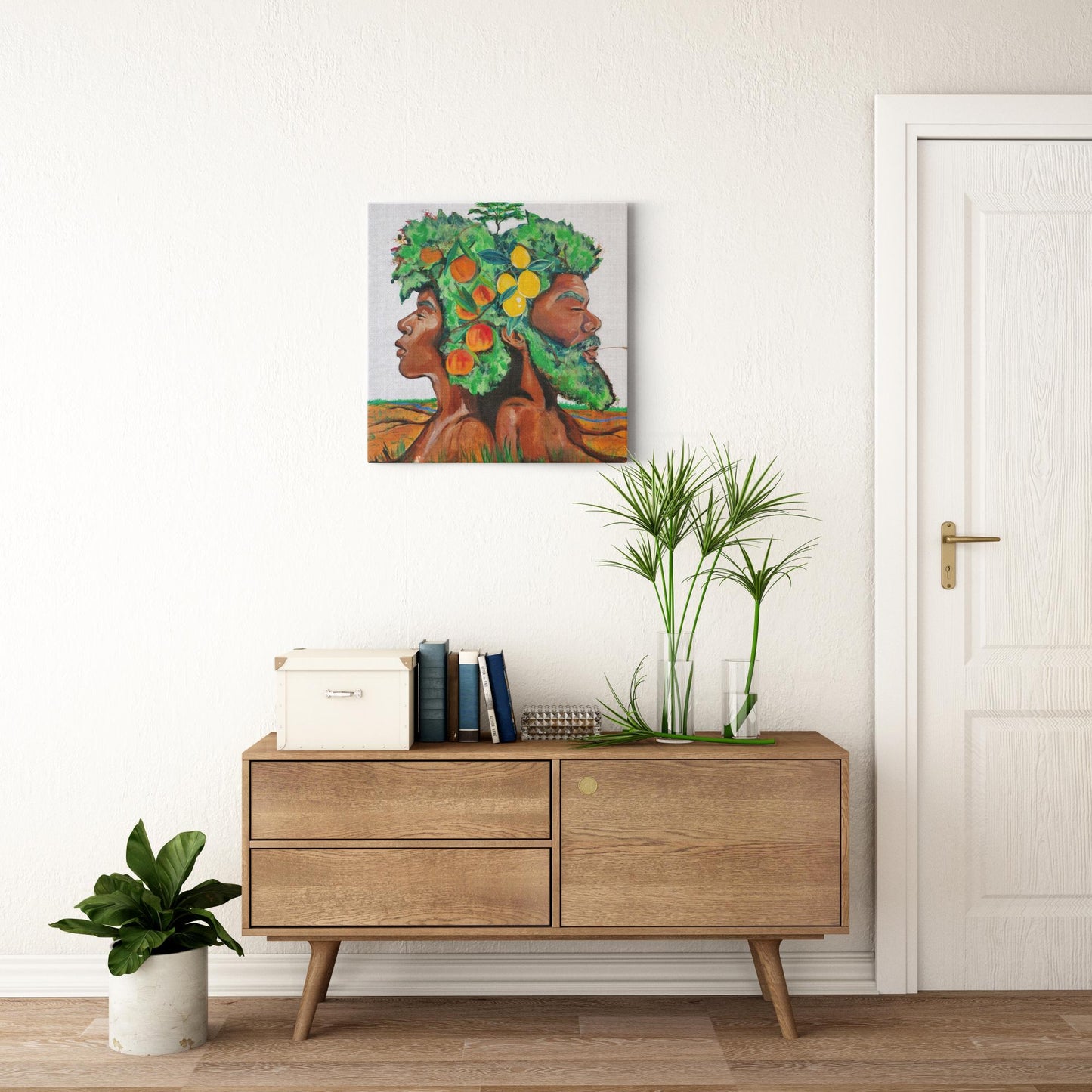 Painting titled “In Good Grace” showing male and female tree figures back-to-back with green afros, bearing fruit and a baby tree, in a serene natural landscape.