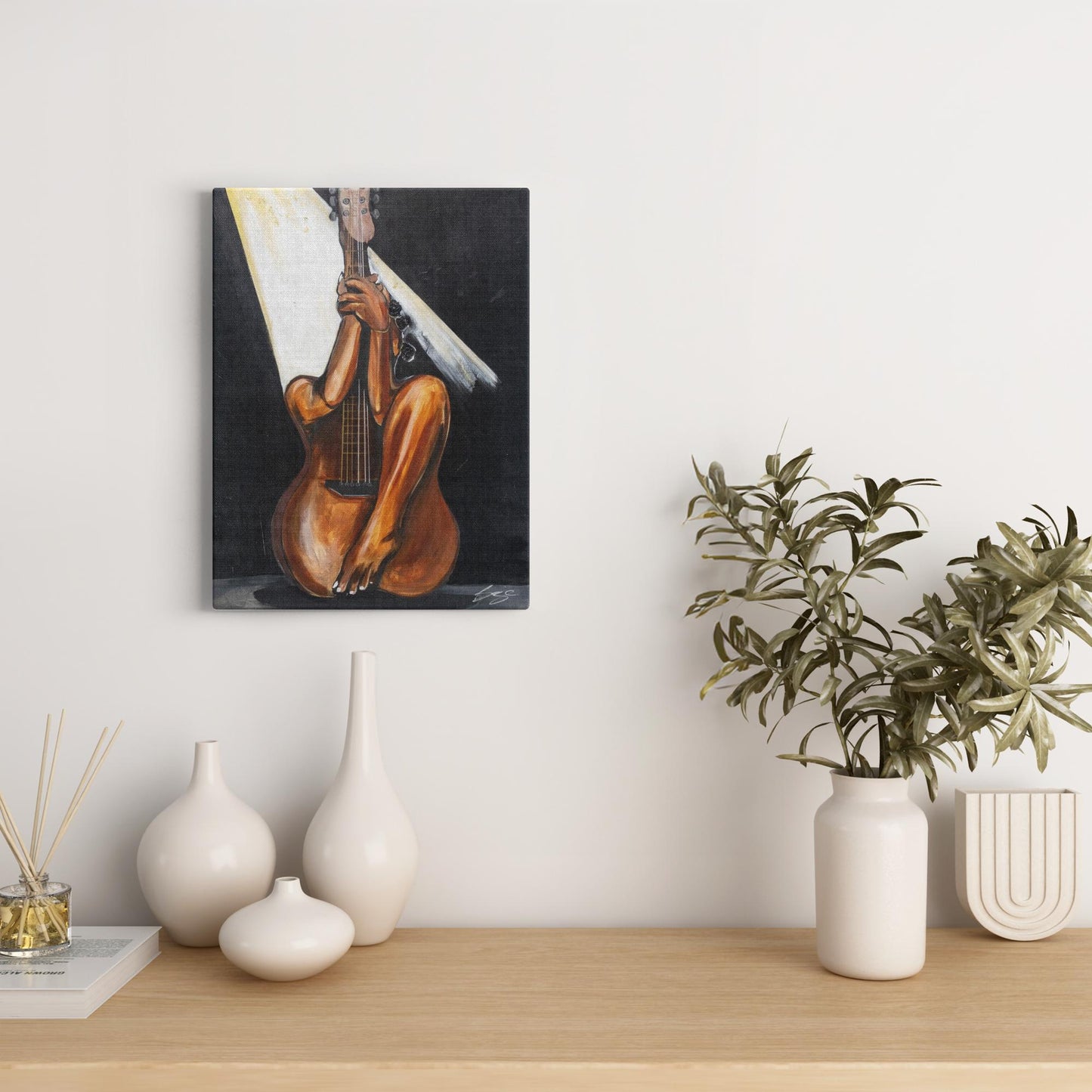 Abstract painting titled “Fine Tuned” showing a woman’s curved body merged with a guitar’s form, one leg extending upward into the neck of the instrument.