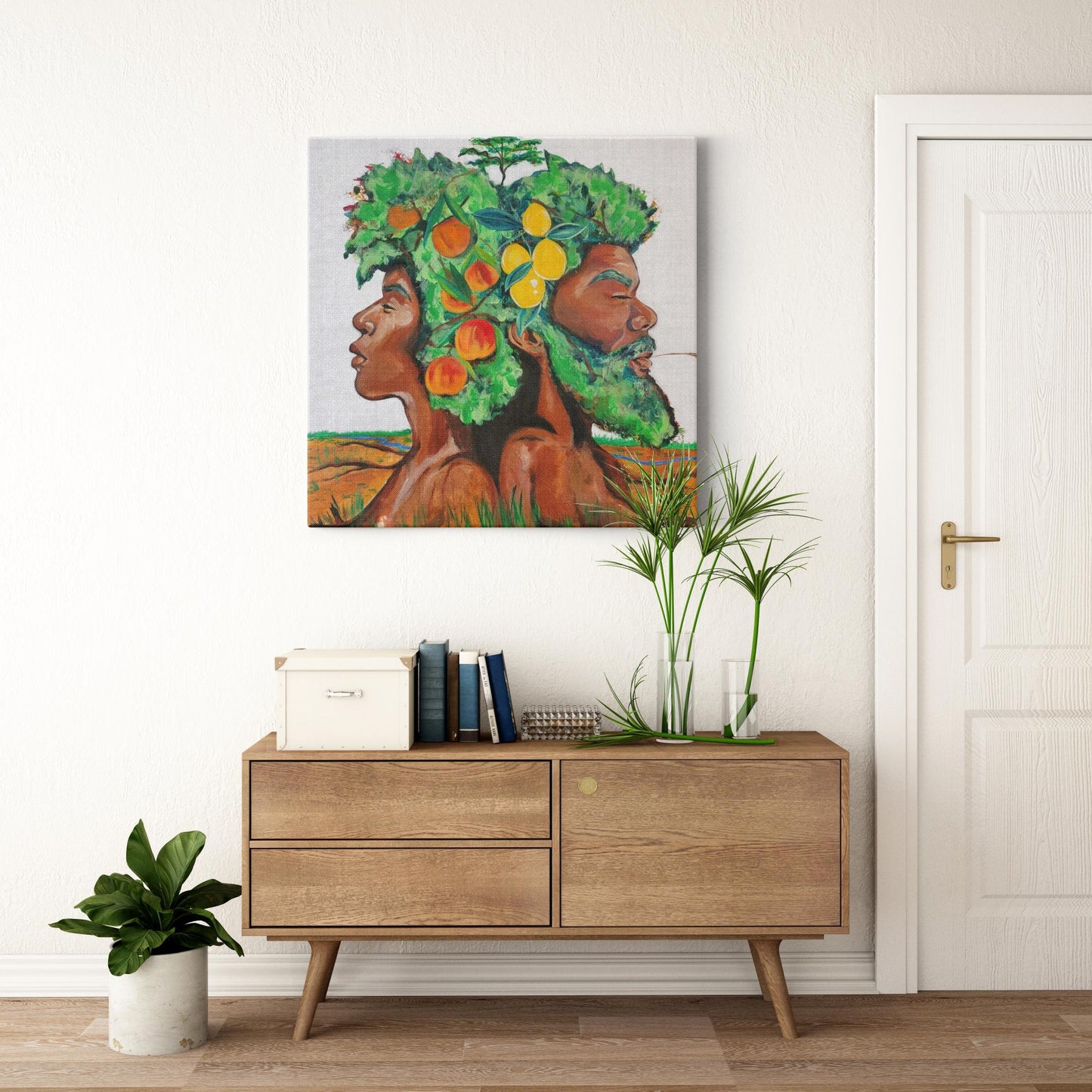 Painting titled “In Good Grace” showing male and female tree figures back-to-back with green afros, bearing fruit and a baby tree, in a serene natural landscape.