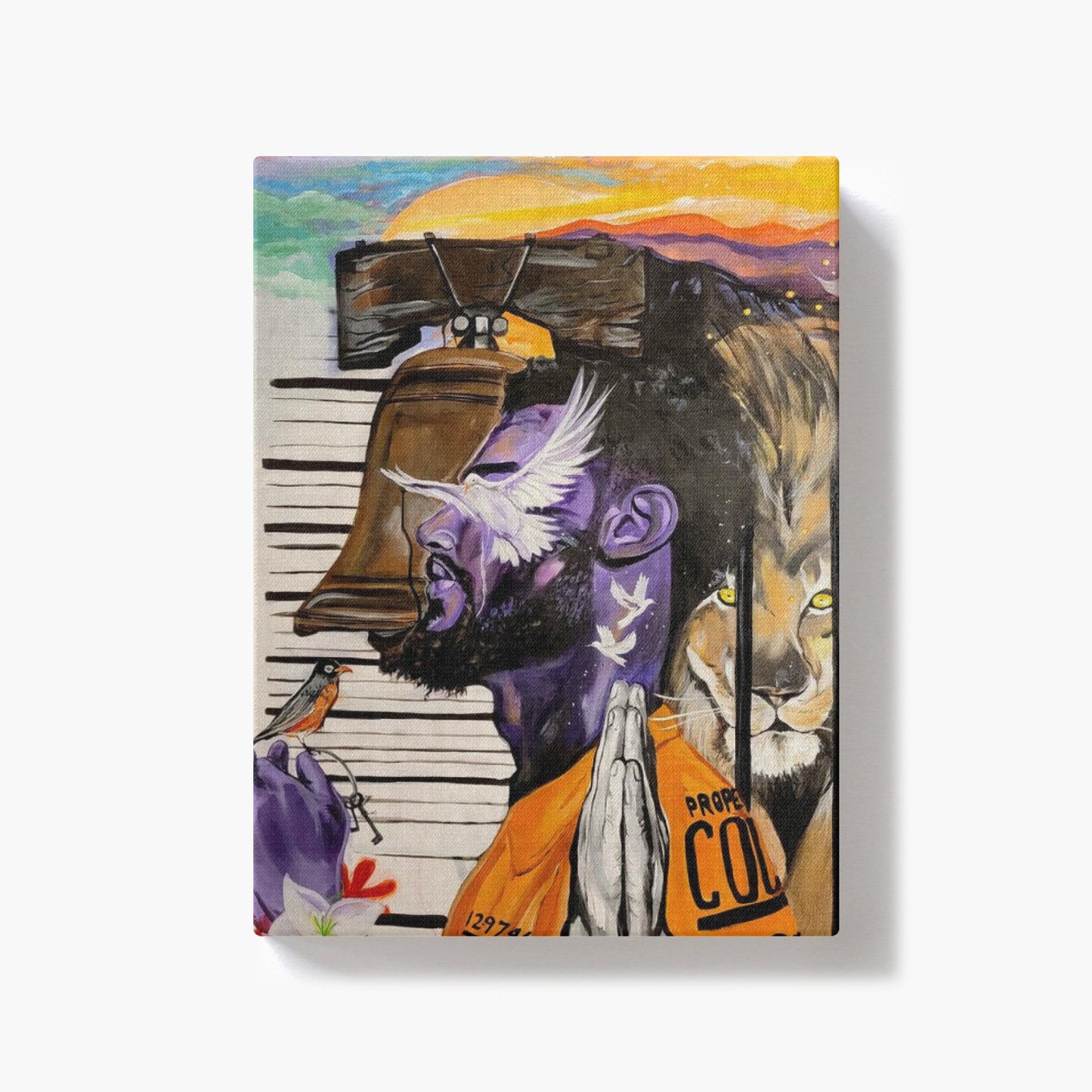 Painting titled “Give Me Liberty” showing a male in a prison jumpsuit kneeling in prayer with a symbolic lion behind bars, liberty bell, and doves representing freedom.