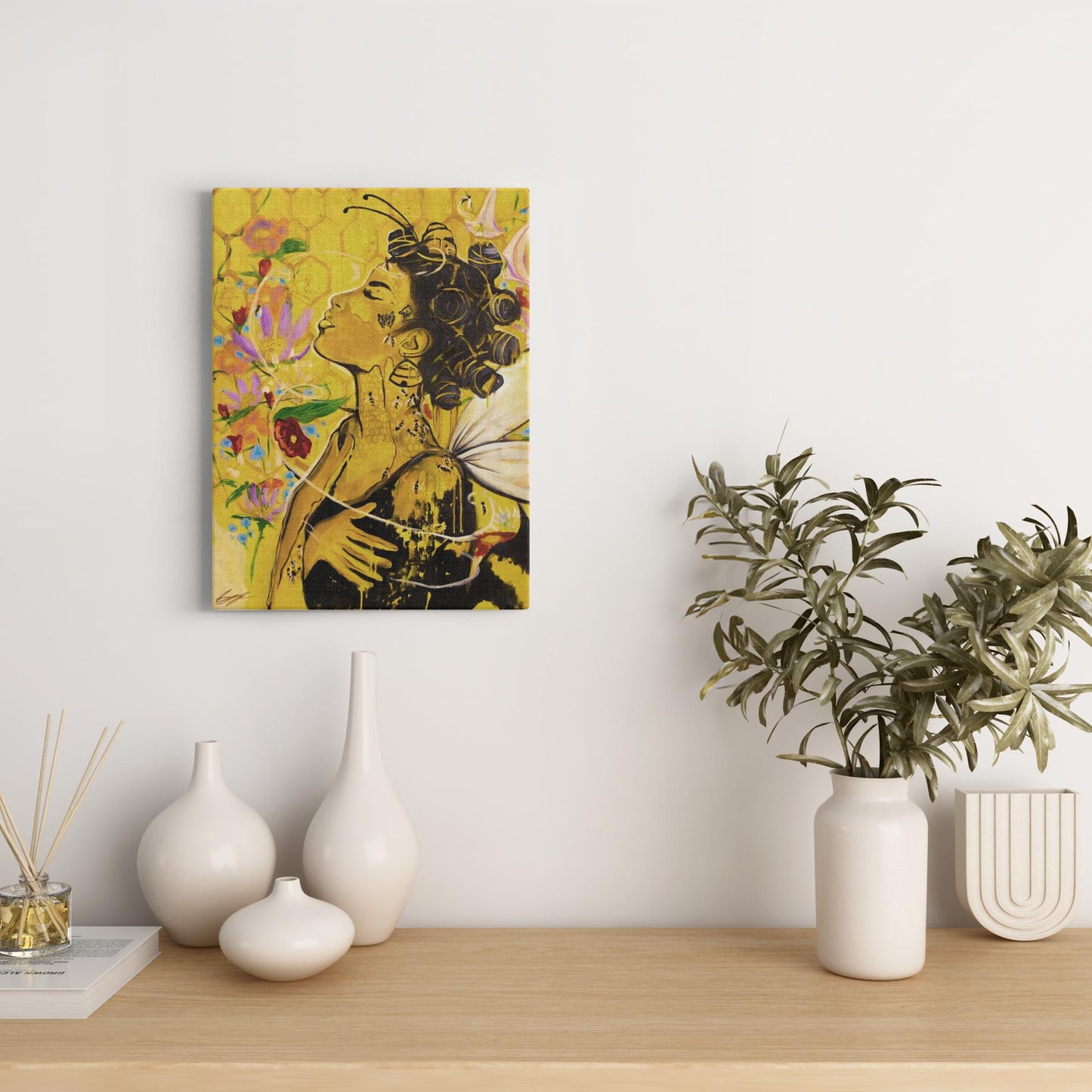 Painting titled “Angelic Butterfly” showing a Black woman with bantu knots, honey-dipped skin, butterfly wings, gold flakes, and bees in a bright yellow setting.