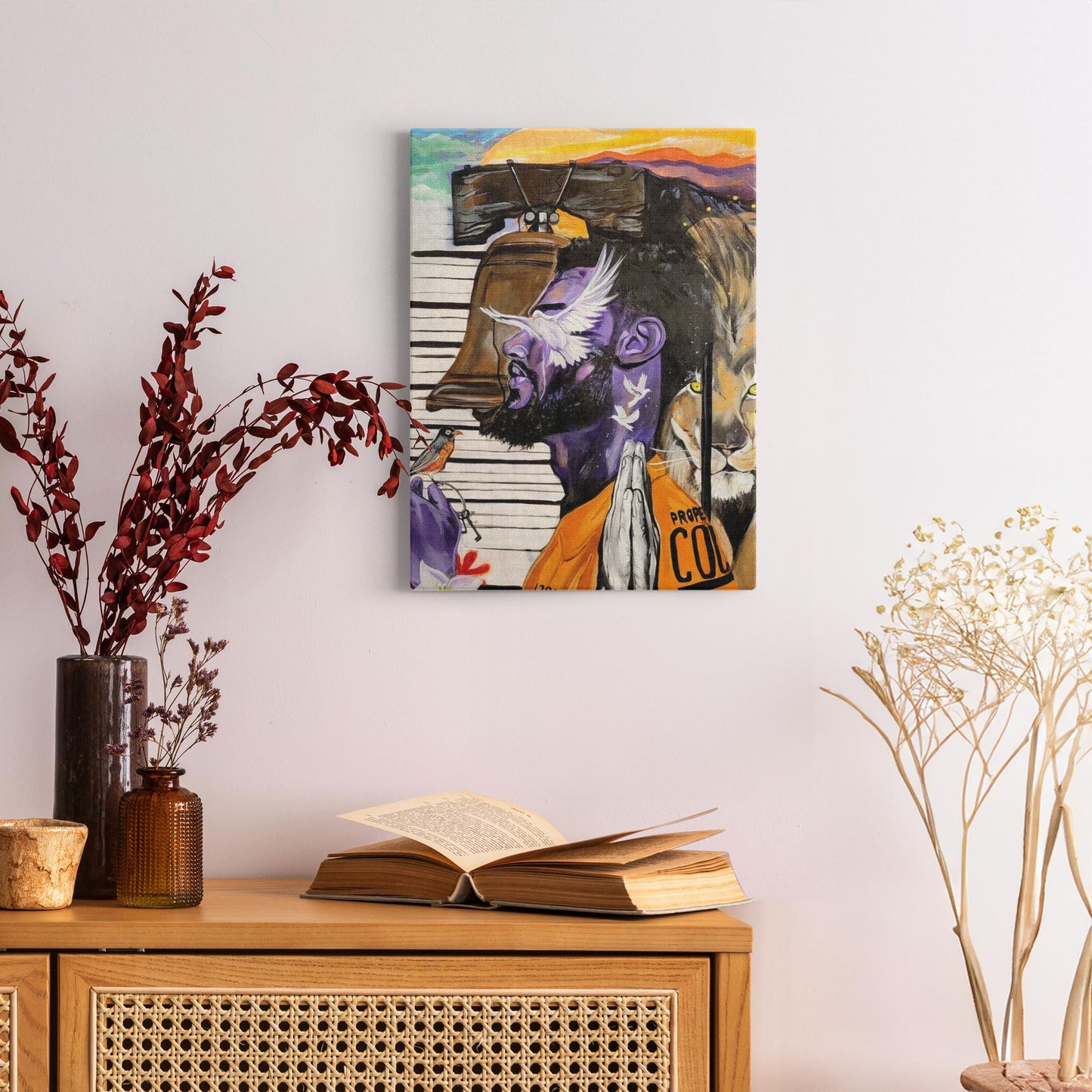 Painting titled “Give Me Liberty” showing a male in a prison jumpsuit kneeling in prayer with a symbolic lion behind bars, liberty bell, and doves representing freedom.